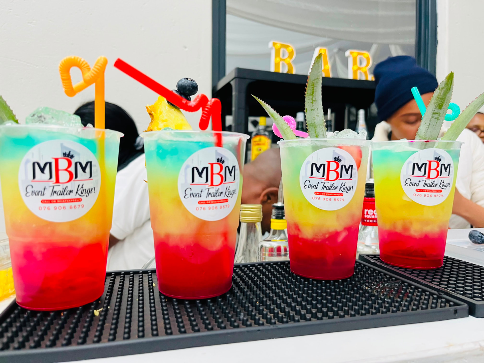 Colourful cocktails served in MBM branded cups